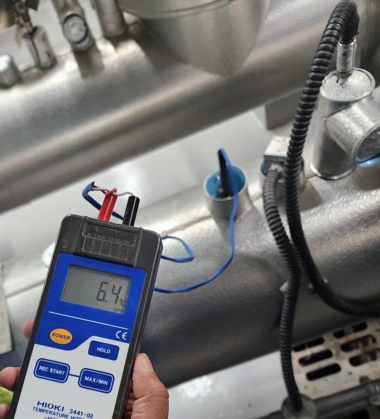 Temperature measurement on HVAC pipework during commissioning.